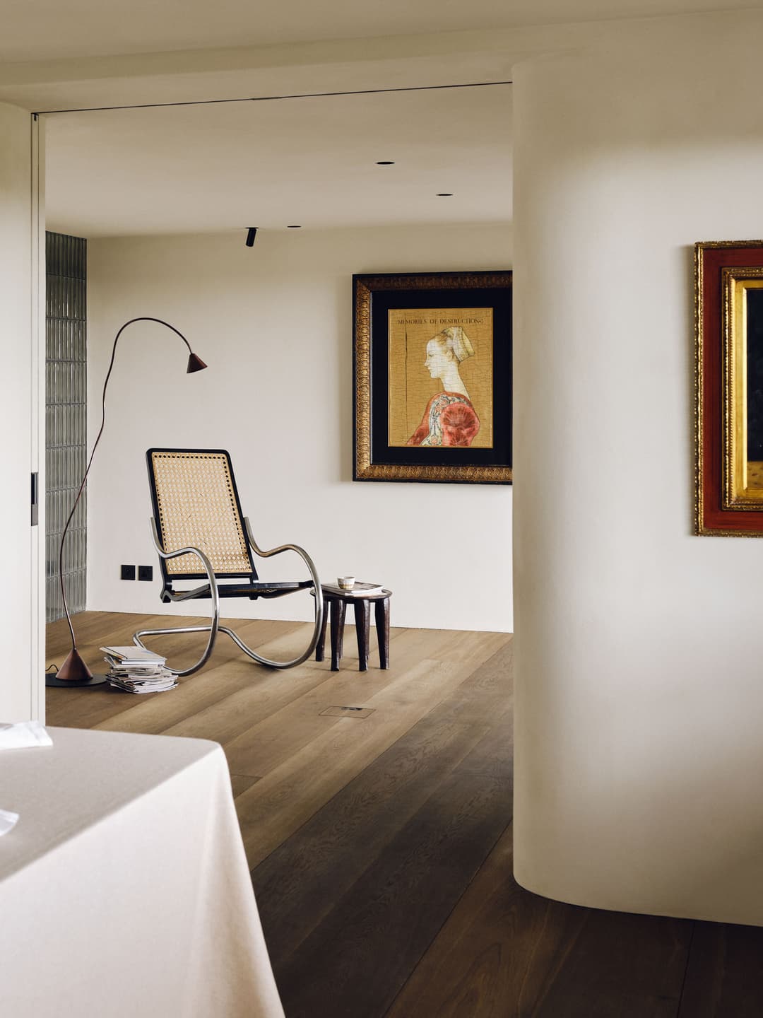 sliding pocket door by Envo within a curved wall separating a dining room and study in a high-end luxury apartment in St John's Wood London